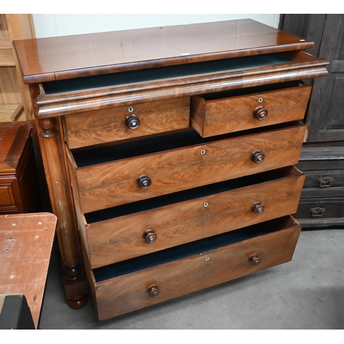 56 - A large Victorian figured mahogany chest with shallow cavetto drawer over two short and three long d... 