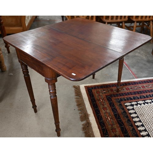 57 - A 19th century mahogany folding tea table on ring turned supports, 90 x 45 x 72 cm high