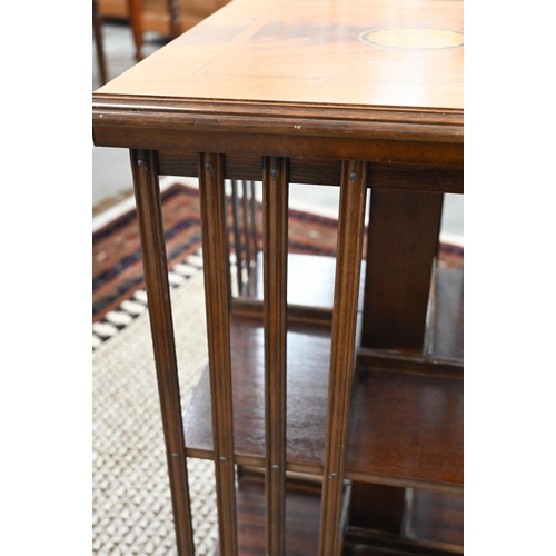 61 - A reproduction bleached mahogany inlaid revolving bookcase, 46 x 46 x 78 cm high