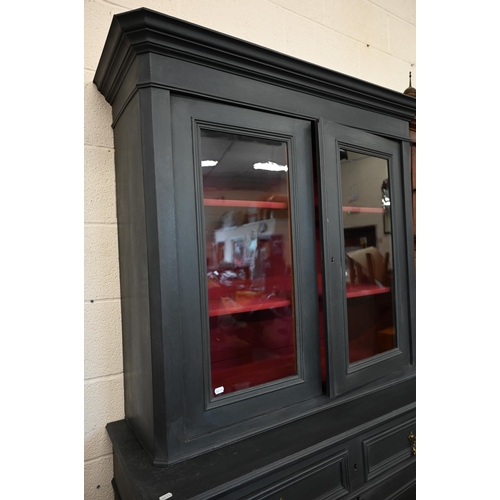 63 - An antique slate open painted bookcase cabinet, the top section with glazed doors enclosing contrast... 