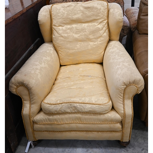 68 - # A wingback armchair, in old gold damask upholstery, to/w another armchair with matching fabric (2)