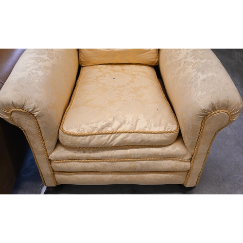 68 - # A wingback armchair, in old gold damask upholstery, to/w another armchair with matching fabric (2)