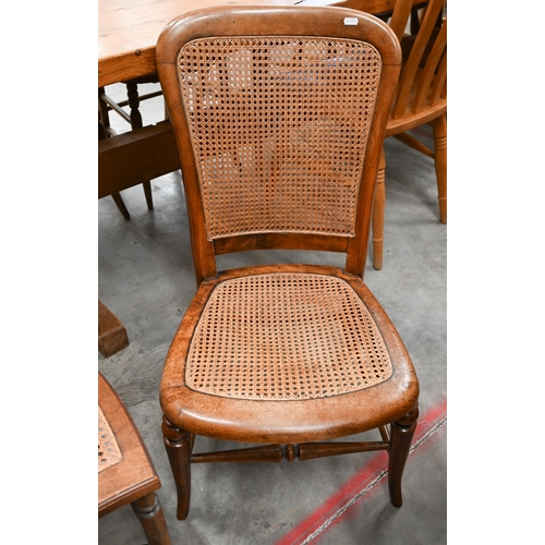 69 - An Edwardian walnut cane seated side chair to/w mahogany nursing chair with caned back and seat (2)