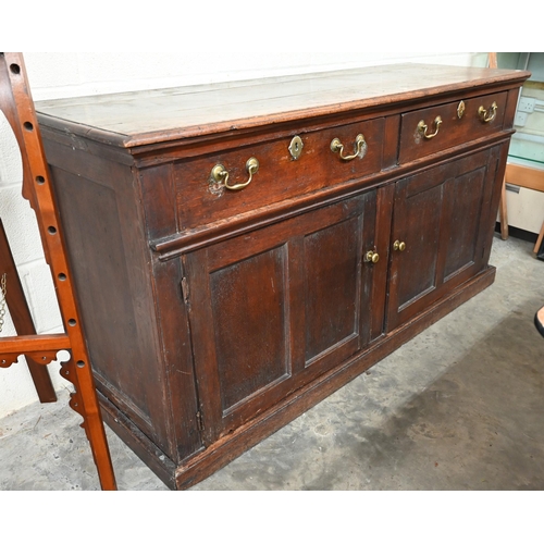 74 - An antique oak dresser base with two drawers over panelled cupboard doors, 172 x 58 x 90 cm high