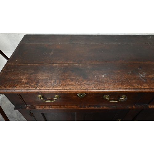 74 - An antique oak dresser base with two drawers over panelled cupboard doors, 172 x 58 x 90 cm high