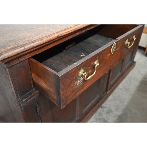 74 - An antique oak dresser base with two drawers over panelled cupboard doors, 172 x 58 x 90 cm high