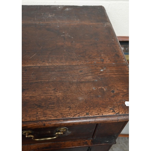 74 - An antique oak dresser base with two drawers over panelled cupboard doors, 172 x 58 x 90 cm high