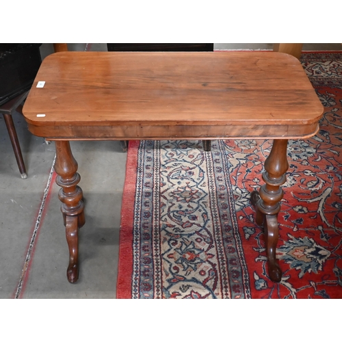 87 - A Victorian mahogany side table on turned supports with shaped legs, a/f