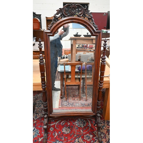 91 - A reproduction stained and carved hardwood cheval mirror, 178 cm high x 85 cm wide