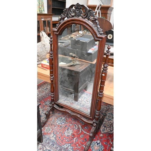 92 - A reproduction stained and carved hardwood cheval mirror, 178 cm high x 85 cm wide