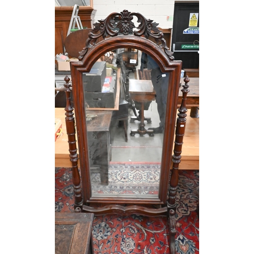 92 - A reproduction stained and carved hardwood cheval mirror, 178 cm high x 85 cm wide