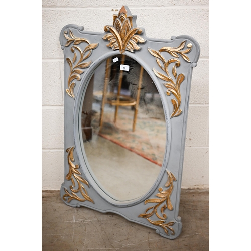 93 - An Indian oval wall mirror in foliate gilded and grey painted decorative frame, 62 cm wide x 96 cm h... 