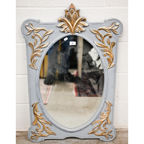 93 - An Indian oval wall mirror in foliate gilded and grey painted decorative frame, 62 cm wide x 96 cm h... 