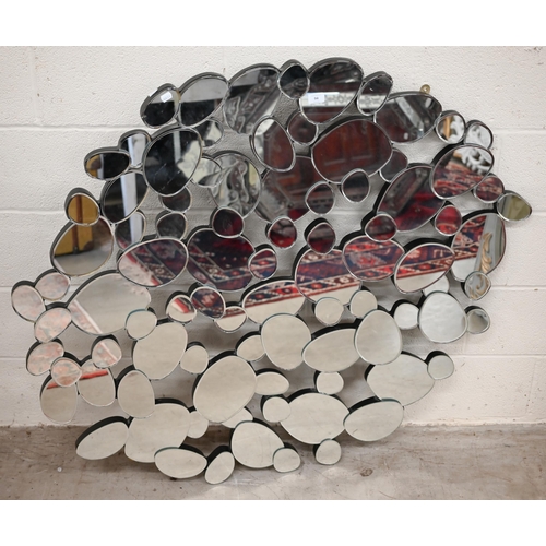 94 - A modern abstract 'pebble' design mirror, 127 cm wide x 114 cm high