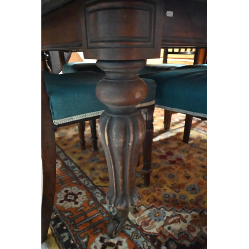 119 - # A 19th century mahogany dining tabe on turned baluster reeded supports and casters, 130 x 130 x 72... 