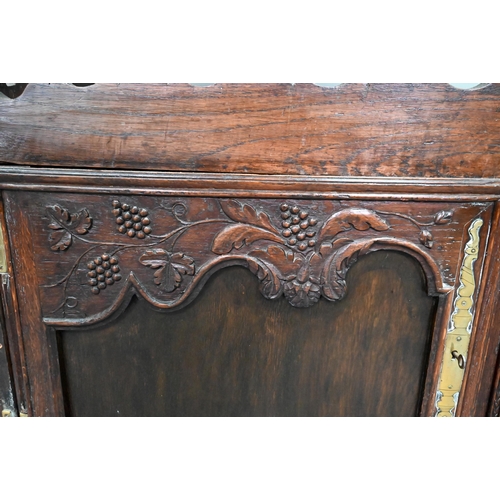 898 - An antique provincial French oak high dresser, the three tier rack with pierced balustrades, over tw... 