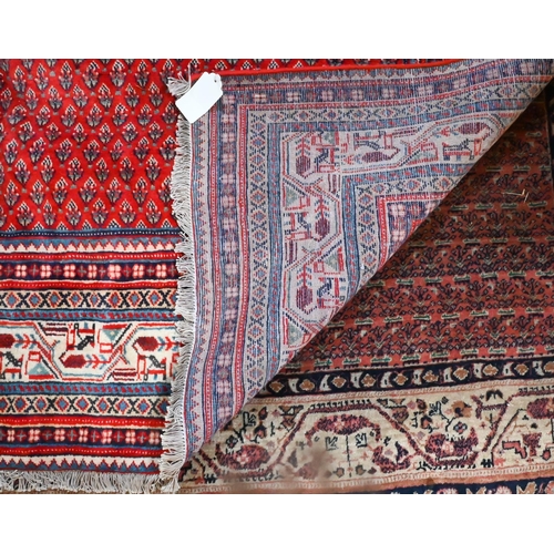 1222 - A Persian Arak carpet, the red ground with repeat all-over design of stylised boteh, 294 cm x 218 cm