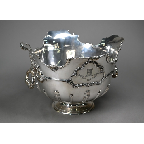 100 - An Edwardian heavy quality silver Monteith with shaped and scrolling rim, swing loop handles and ste... 