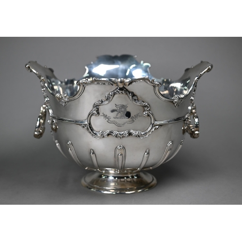 100 - An Edwardian heavy quality silver Monteith with shaped and scrolling rim, swing loop handles and ste... 