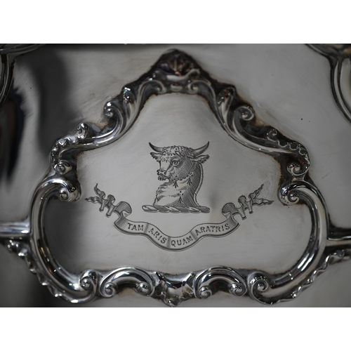 100 - An Edwardian heavy quality silver Monteith with shaped and scrolling rim, swing loop handles and ste... 