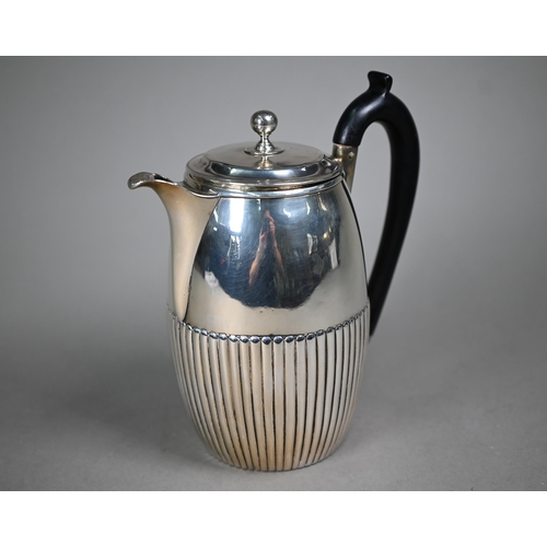 106 - A George III silver coffee jug of ovoid form with ebonised handle and half-reeded decoration, Thomas... 