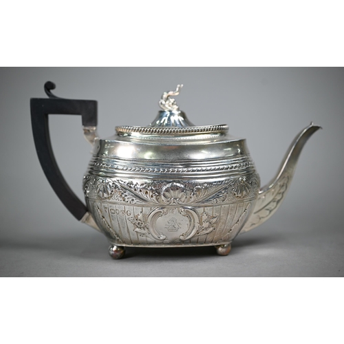 107 - A Victorian silver tea pot in the Regency taste, with dolphin finial and composite handle, on bun fe... 