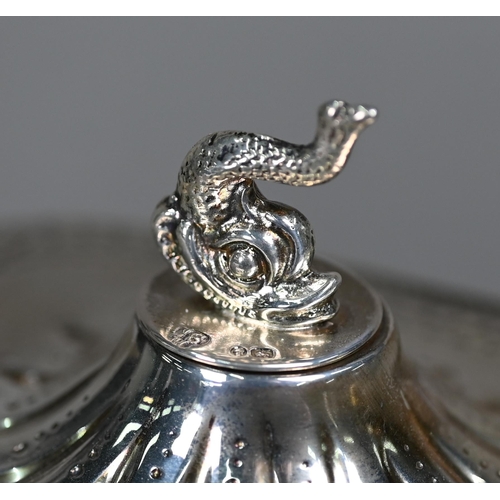 107 - A Victorian silver tea pot in the Regency taste, with dolphin finial and composite handle, on bun fe... 