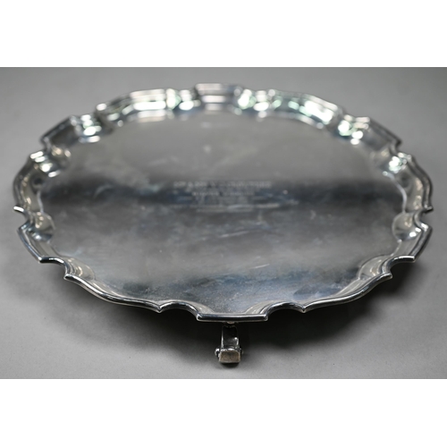 113 - A silver salver with moulded rim, on three scroll feet, William Greenwood & Sons, Birmingham 194... 