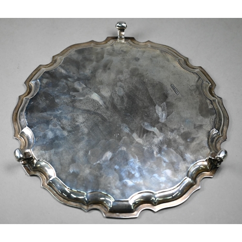 113 - A silver salver with moulded rim, on three scroll feet, William Greenwood & Sons, Birmingham 194... 