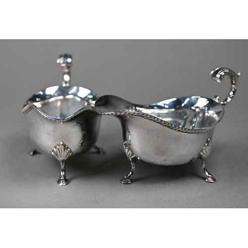 119 - A pair of silver sauce boats with gadrooned rims and scroll handles, on hoof feet, Roberts & Bel... 