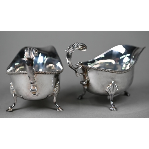 119 - A pair of silver sauce boats with gadrooned rims and scroll handles, on hoof feet, Roberts & Bel... 