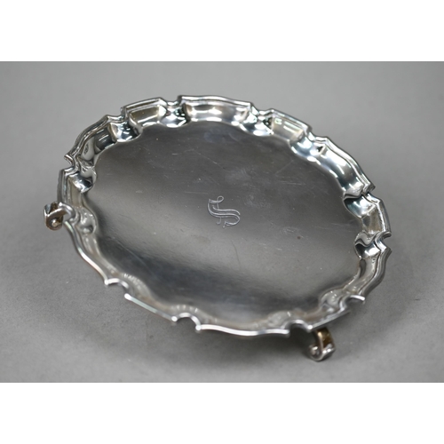 120 - A silver card salver in the Georgian taste, with moulded rim and three scroll feet, Adie Bros, Birmi... 