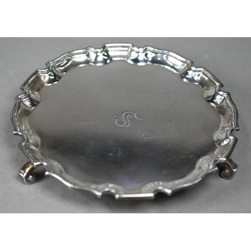 120 - A silver card salver in the Georgian taste, with moulded rim and three scroll feet, Adie Bros, Birmi... 