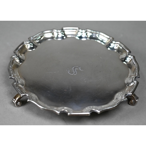 120 - A silver card salver in the Georgian taste, with moulded rim and three scroll feet, Adie Bros, Birmi... 