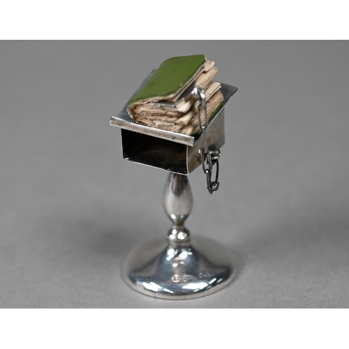 122 - A novelty silver miniature lectern, containing a miniature New Testament (book a/f), Henry Williamso... 