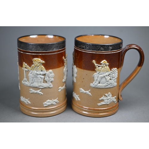 127 - An Edwardian pair of Royal Doulton stoneware pint beer-mugs with silver rims, Mappin & Webb, Lon... 