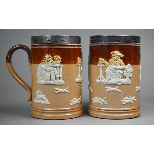 127 - An Edwardian pair of Royal Doulton stoneware pint beer-mugs with silver rims, Mappin & Webb, Lon... 