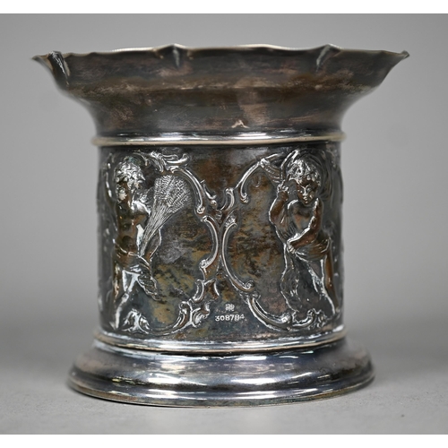 143 - An Edwardian silver sleeve bottle coaster, the sides embossed and chased with cherubs depicting the ... 