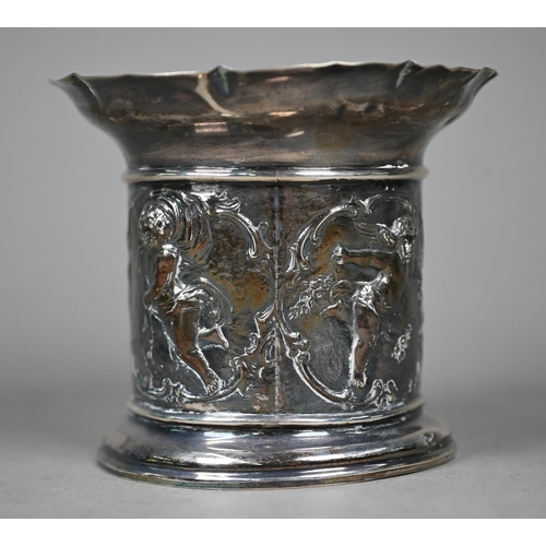 143 - An Edwardian silver sleeve bottle coaster, the sides embossed and chased with cherubs depicting the ... 