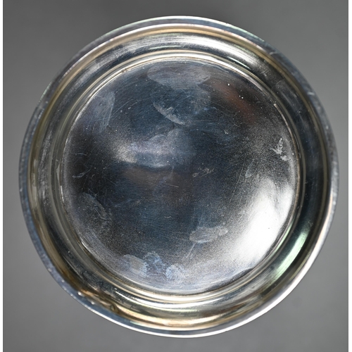 143 - An Edwardian silver sleeve bottle coaster, the sides embossed and chased with cherubs depicting the ... 