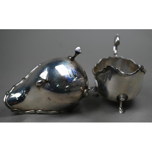 164 - A pair of silver sauce-boats with moulded rims and scroll handles, on hoof feet, Mappin & Webb, ... 