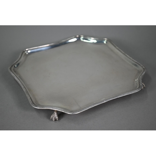 180 - An octagonal silver salver with beaded rim and four claw & ball feet, Fenton Bros Ltd., Sheffiel... 