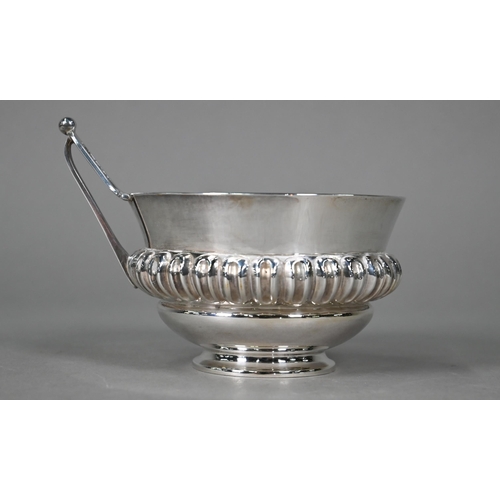 183 - A Victorian silver wine-cup with reeded and fluted waist and angular handle, on raised foot-rim, Hor... 