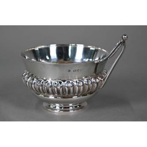 183 - A Victorian silver wine-cup with reeded and fluted waist and angular handle, on raised foot-rim, Hor... 