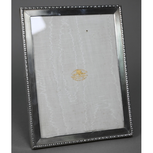 185 - An engine-turned silver photograph frame, Goldsmiths & Silversmiths Co. Ltd., London 1935, 23.5 ... 