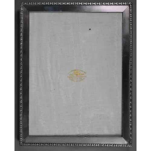 185 - An engine-turned silver photograph frame, Goldsmiths & Silversmiths Co. Ltd., London 1935, 23.5 ... 