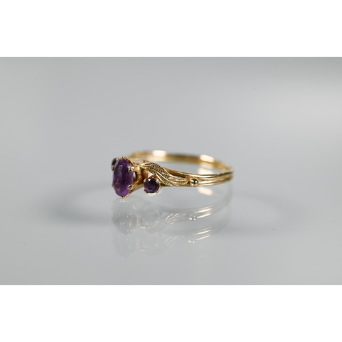 203 - Three 9ct yellow gold rings - a three-stone amethyst in scroll setting, garnet cluster and two stone... 