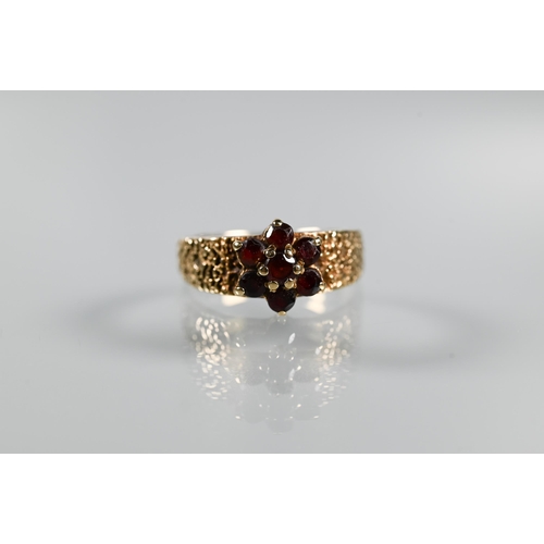 203 - Three 9ct yellow gold rings - a three-stone amethyst in scroll setting, garnet cluster and two stone... 