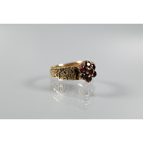 203 - Three 9ct yellow gold rings - a three-stone amethyst in scroll setting, garnet cluster and two stone... 