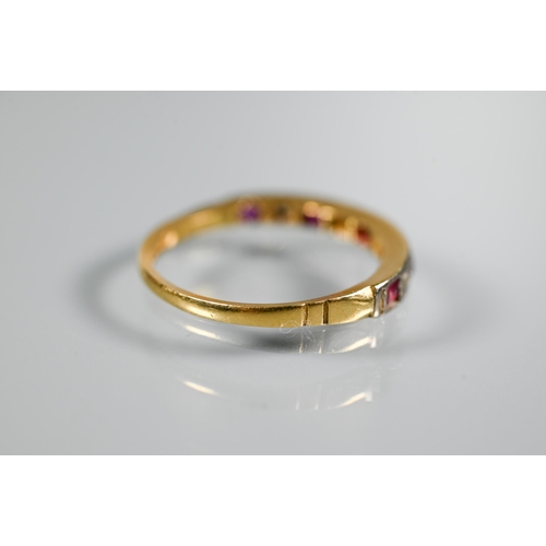 214 - An 18ct yellow gold half eternity ring set rubies and diamonds, size M 1/2, shank worn